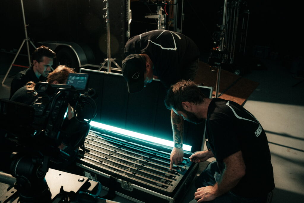 Our Lighting Team syncing up multiple fixtures from our trailer package on a commercial video production in a Tampa studio.