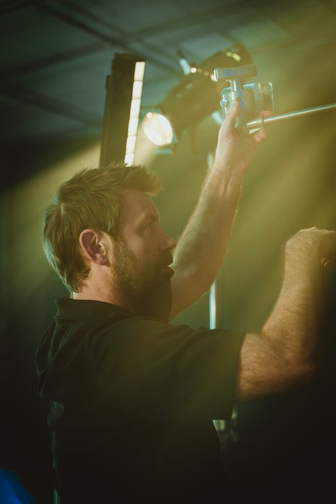 Our Chief Lighting Tech adjusting one of our many LED fixtures in our trailer package on a commercial video production in St Petersburg